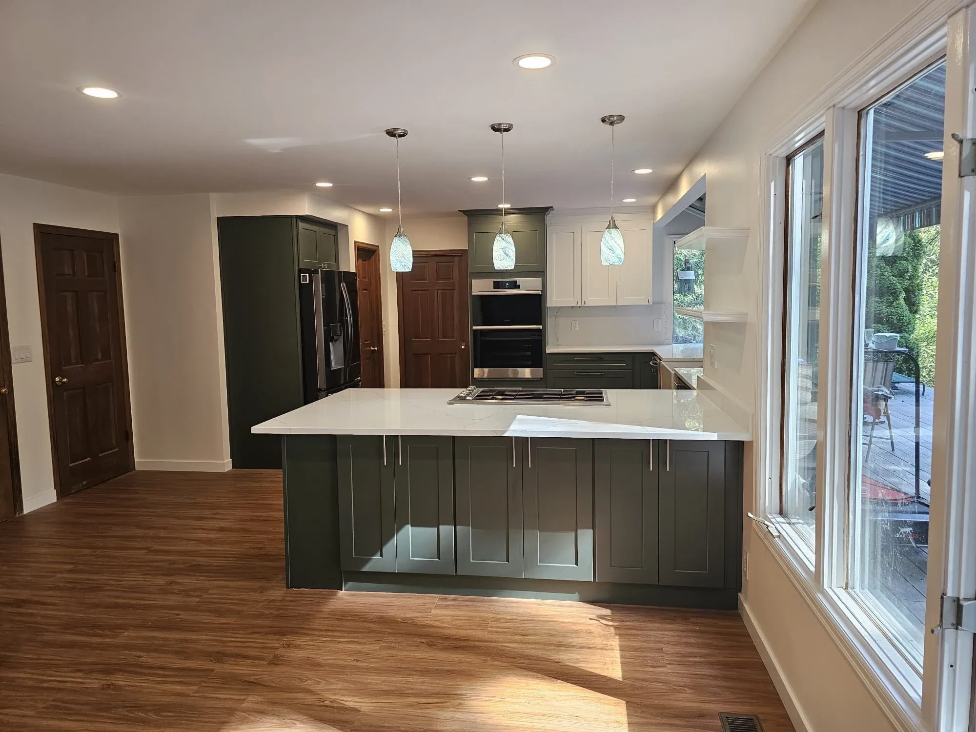 Luxury navy kitchen with dark cabinetry and warm pendant lighting